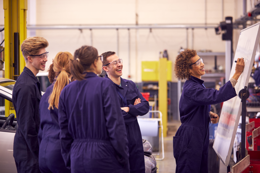 Female-Tutor-By-Whiteboard-With-Students-Teaching-Auto-Mechanic-Apprenticeship-At-College-2048x1365